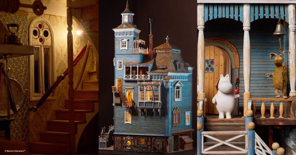 An intricate exhibit inside the Tampere Moomin Museum showcasing a detailed miniature Moomin Valley diorama with Moomin characters and buildings.