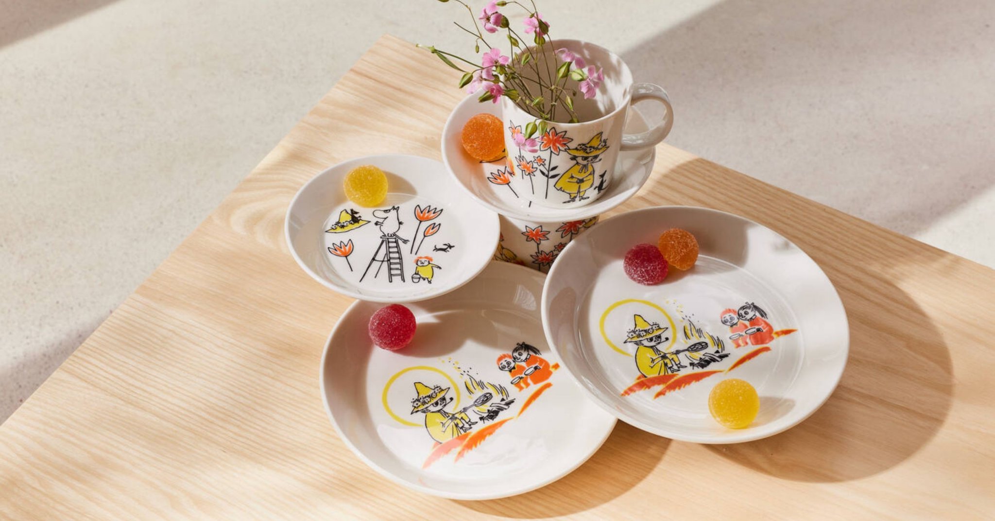 Arabia and Red Cross Moomin dinnerware collection stacked on a table